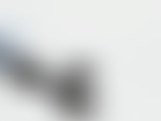 One opto-isolator is in a clear blue container, and five opto-isolators are staggered on a white surface.