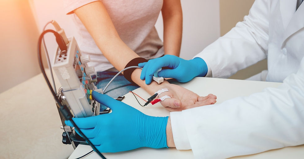 A close-up of a doctor using an electronic device connected to a patient's forearm to measure their pulse.
