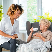 Picture of Senioe Enjoying Tea and Caregiver