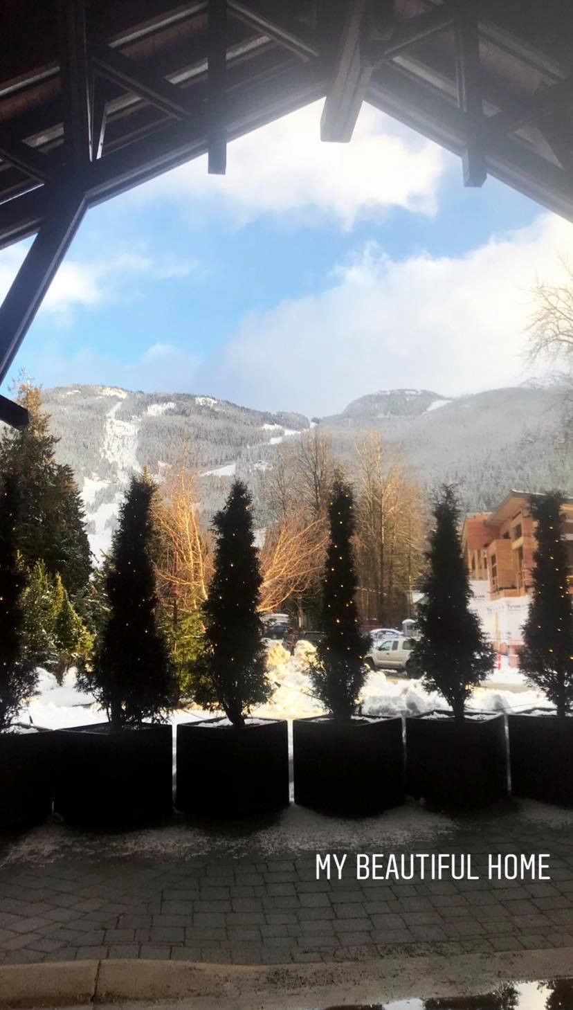 Beautiful mountain backdrop view, from Nita Lake lodge arch, with blue skies and trees