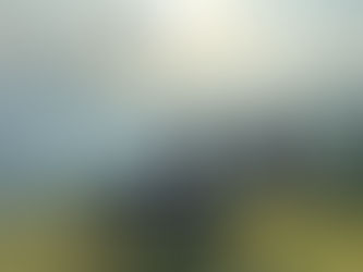 Girl on motorbike looks at mountains over her shoulder