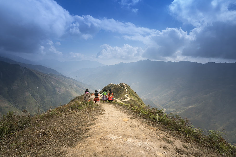 Children walking hand in hand through Ha Giang landscape