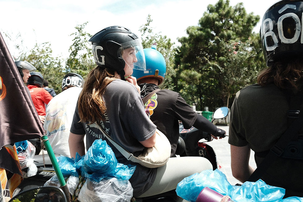 An easy rider and his passenger are waiting at a stop sign