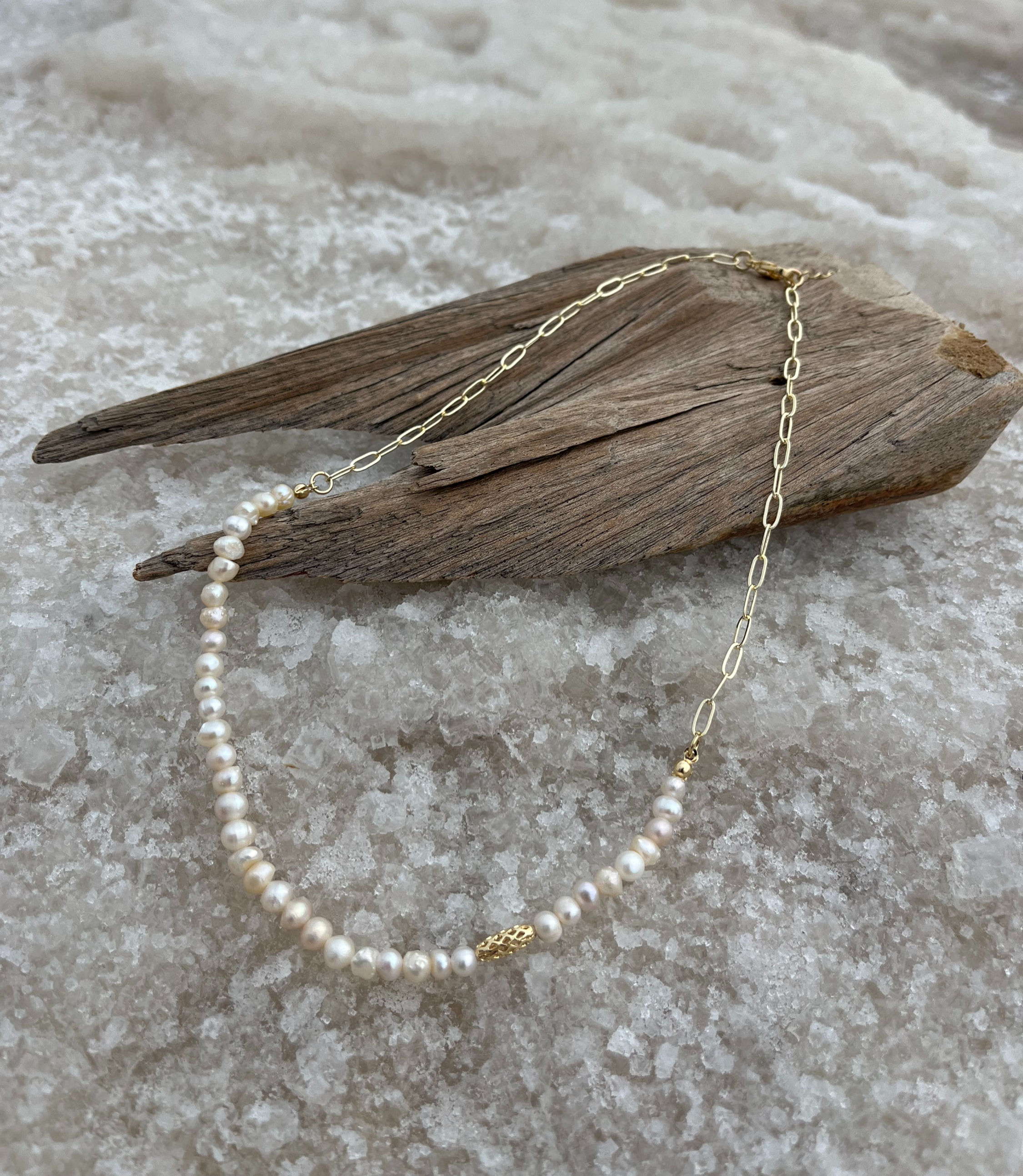 Pearl and gold paperclip chain necklace with a unique gold bead