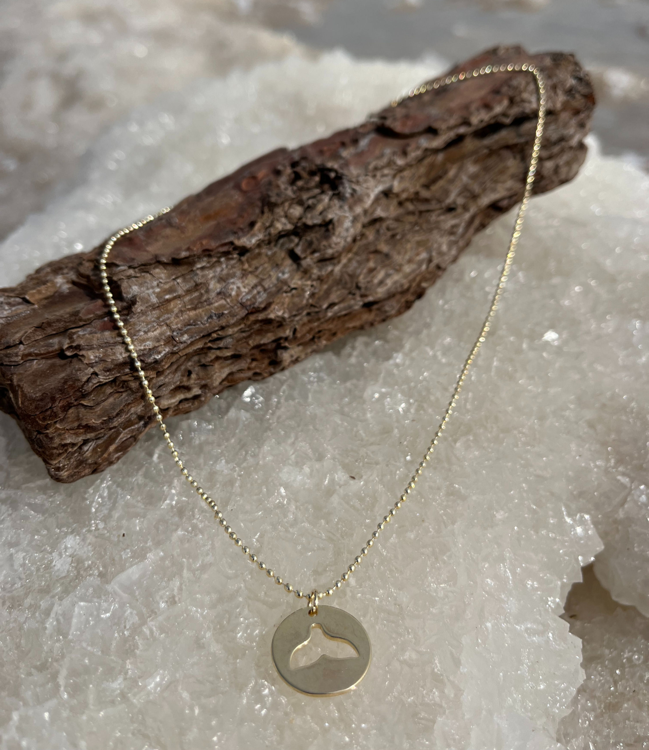Gold ball chain necklace with a round whale tail pendant