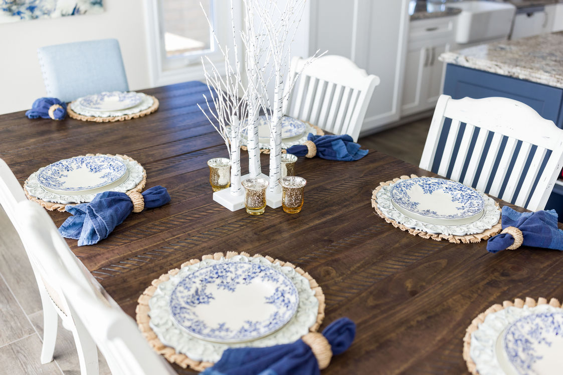 Blue and white table setting on a dark wood dining table