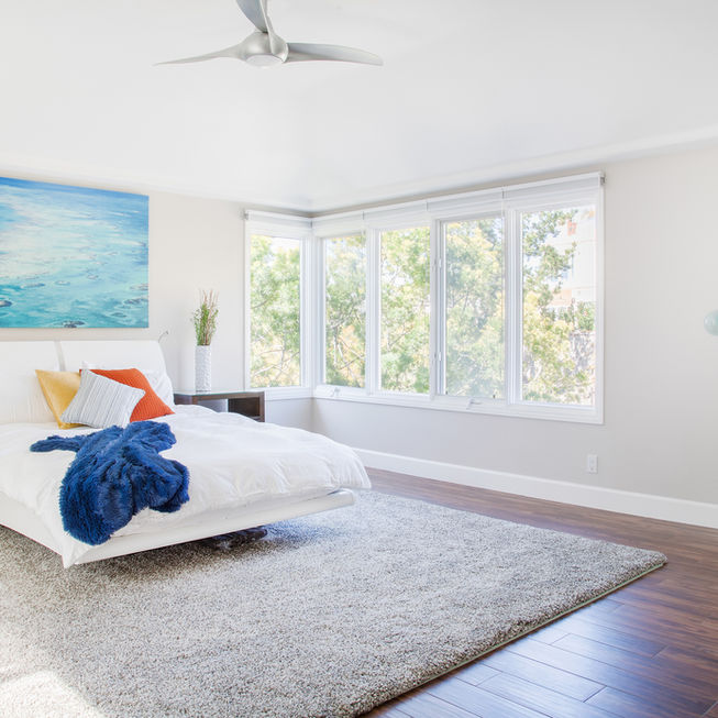 Modern bedroom with white walls and ocean-themed decor