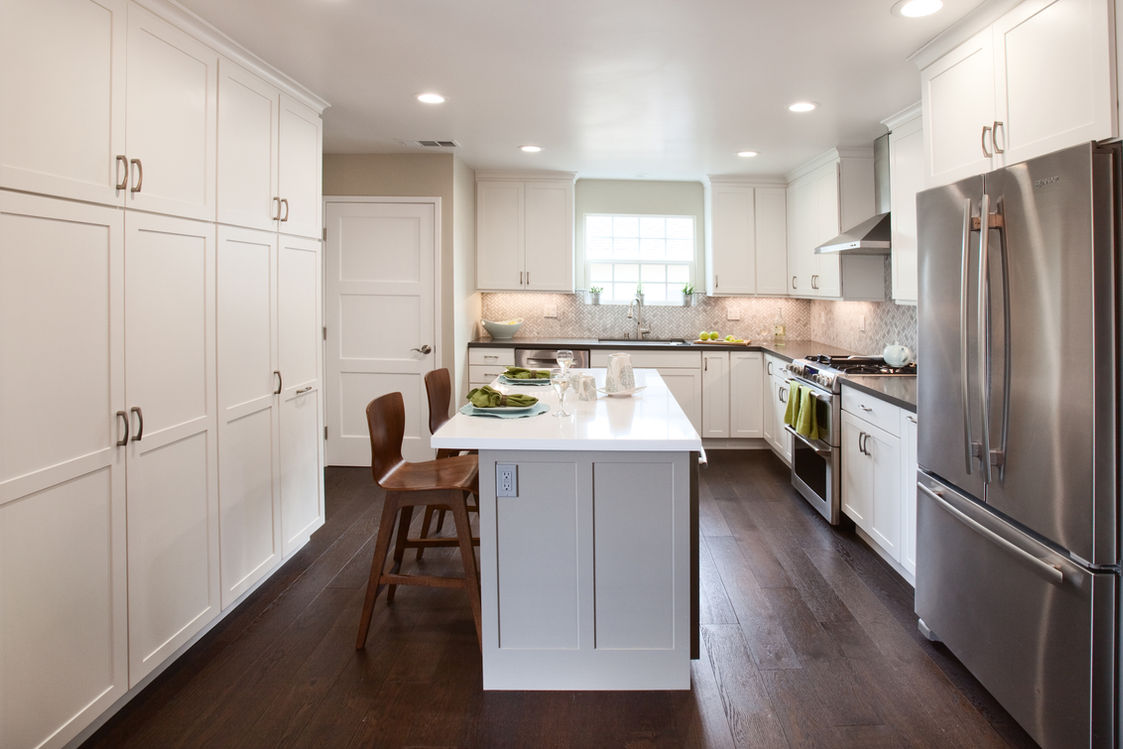 Modern white kitchen with island and stainless steel appliances