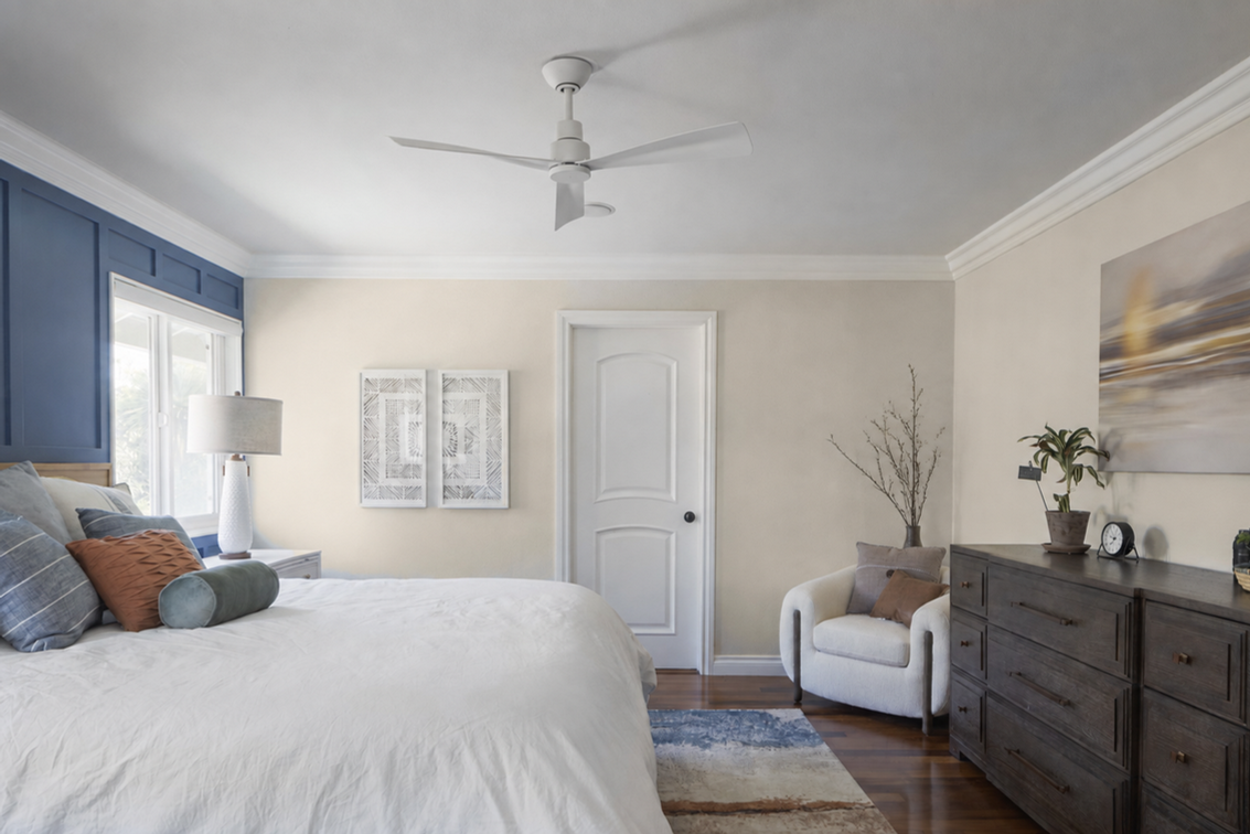 Modern bedroom with blue accent wall and white ceiling fan