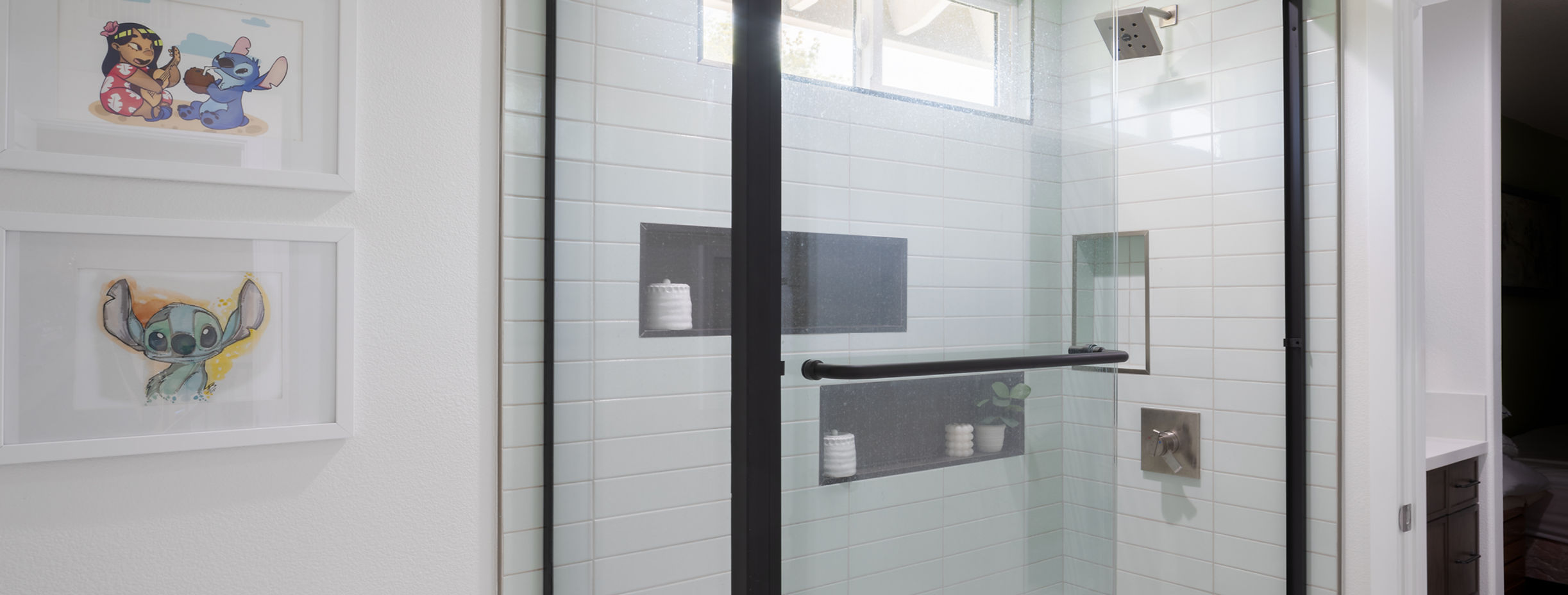 Modern bathroom with black-framed glass tub enclosure
