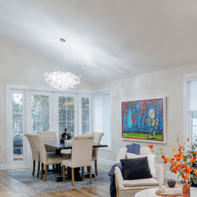 Modern open living room and dining area with blue sofa.