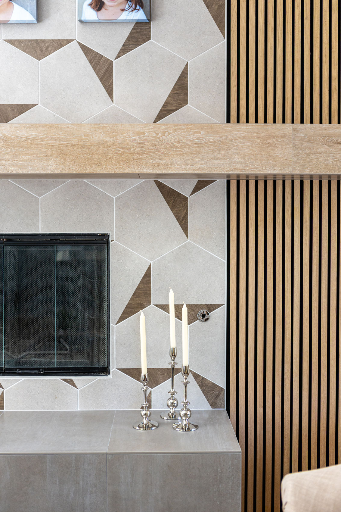 Modern fireplace with geometric tiles and wood slats