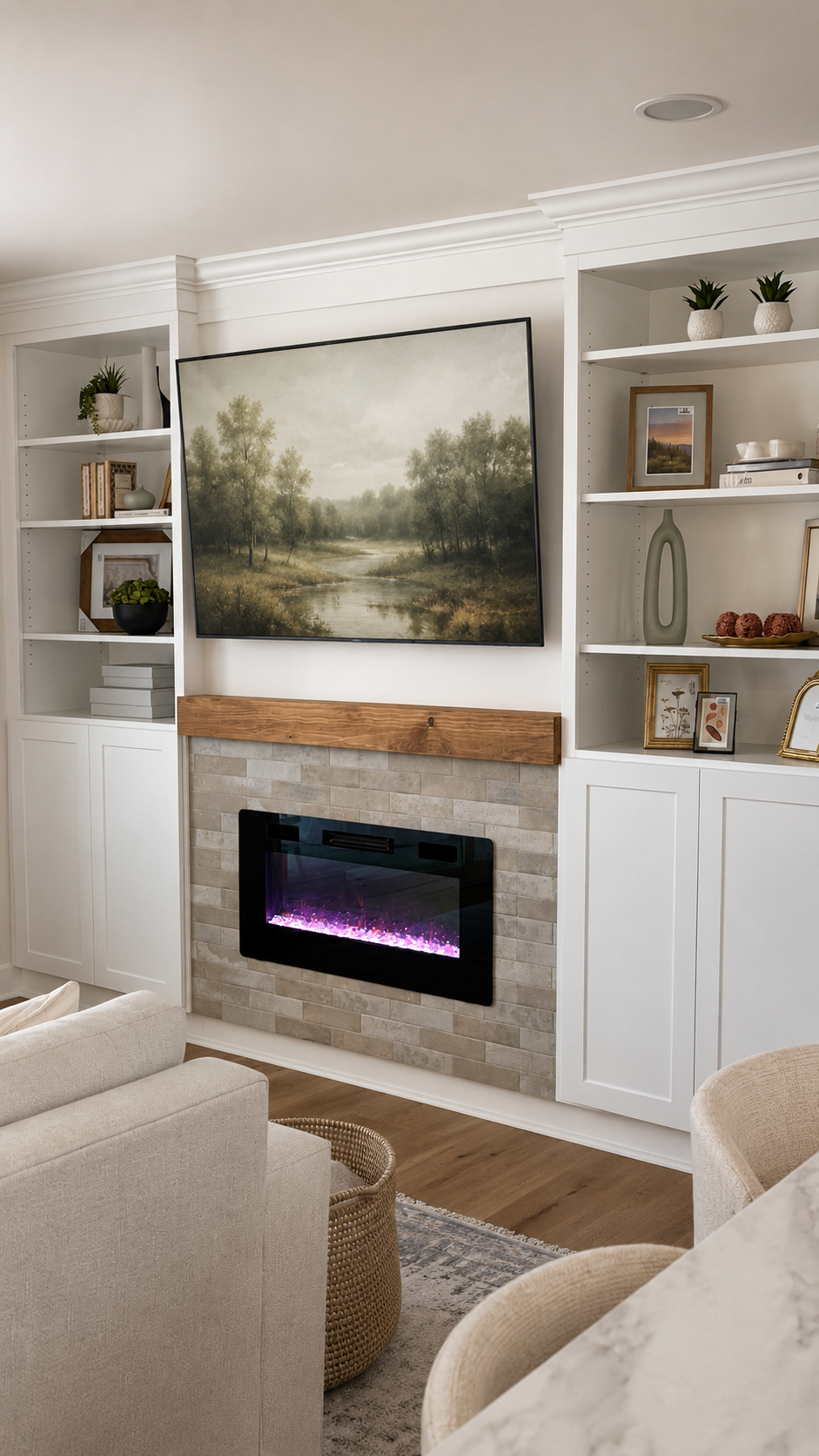 Modern fireplace with white built-in shelving and landscape art
