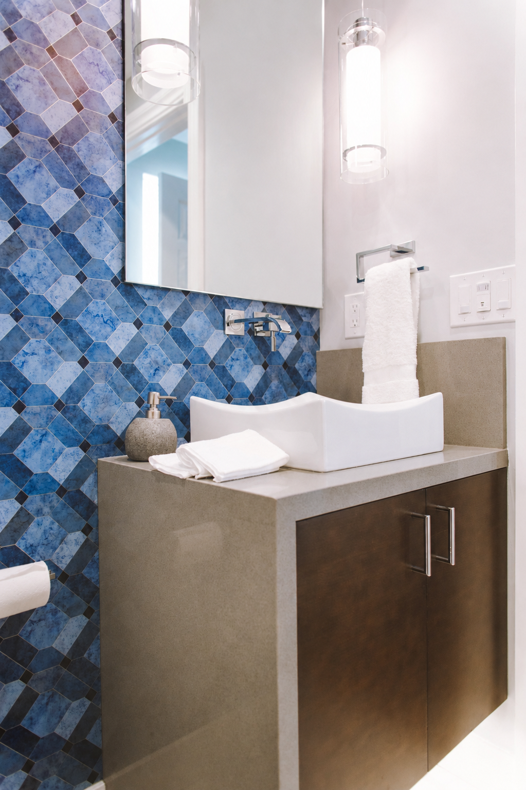 Modern bathroom vanity with blue mosaic tile backsplash