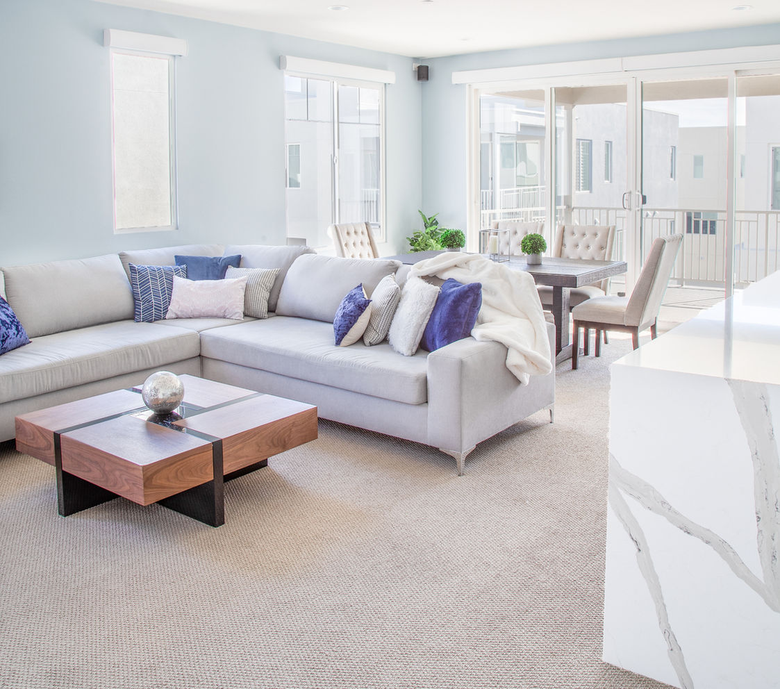 Modern living room with grey sectional and wood coffee table