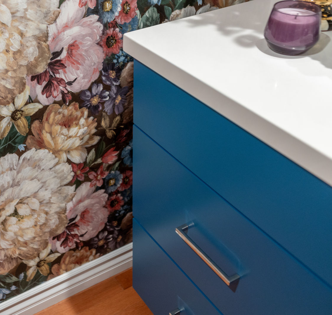 Blue dresser against floral wallpaper