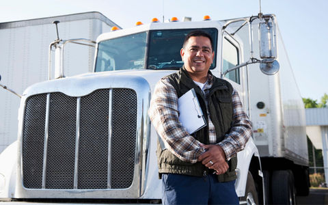 Hot Shot Trucker Standing In Front of Their Rig
