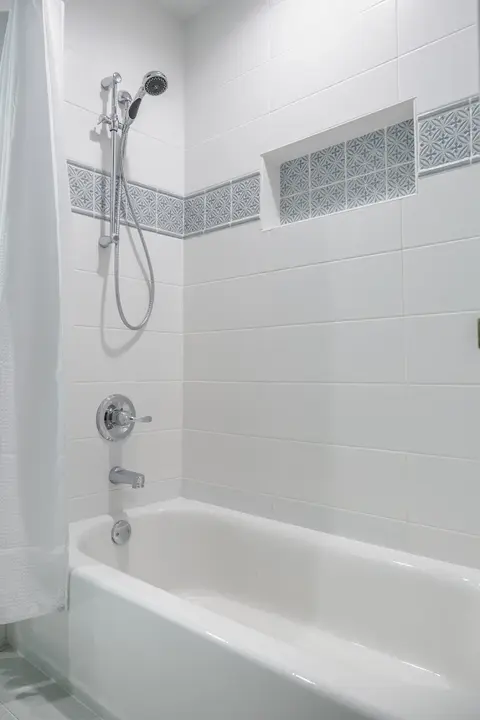 A Bathroom Complete With Tile Walls & a New Tub