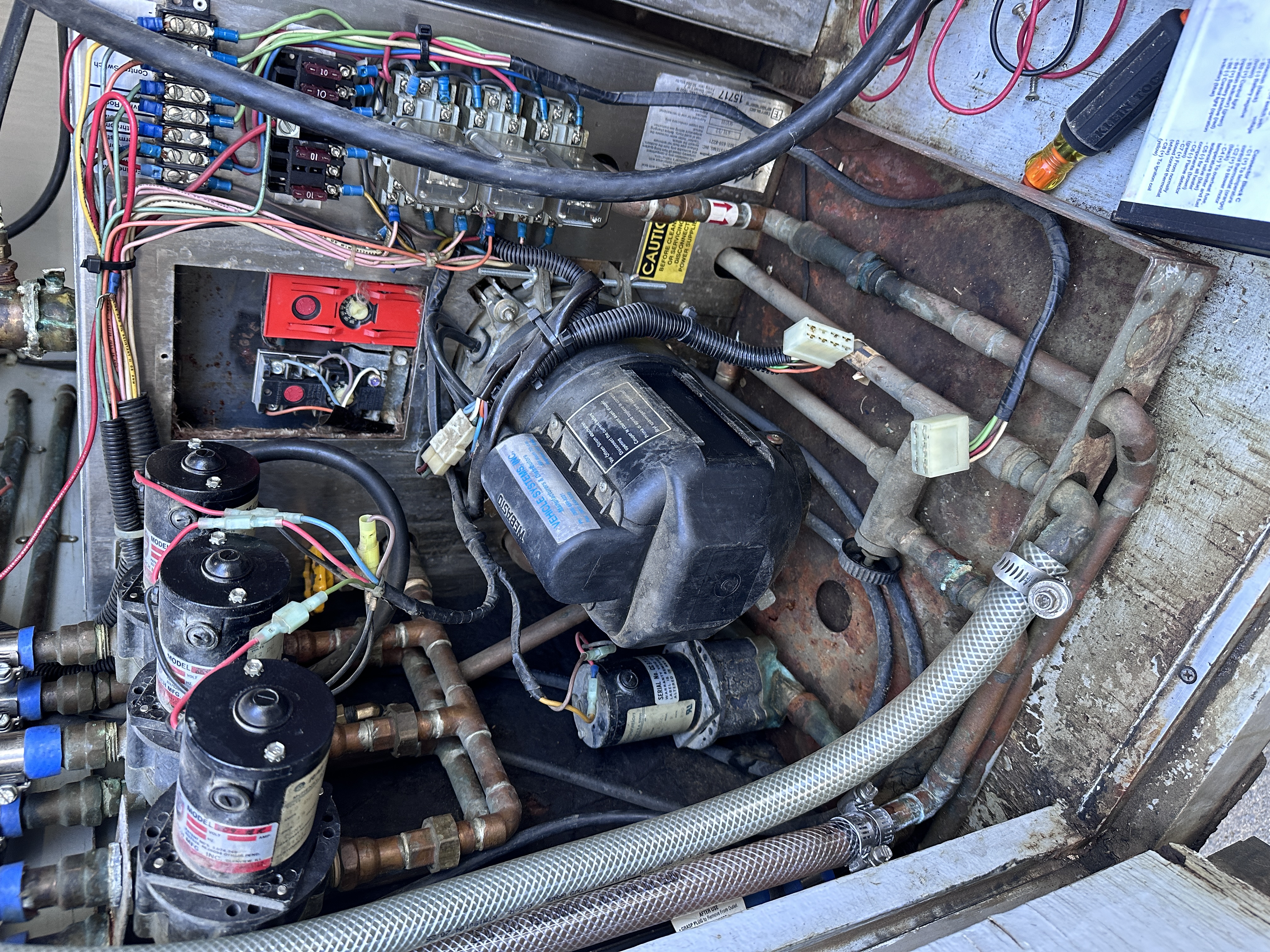 Aqua-Hot equipment bay showing the burner, circulation plumbing, hoses and electrical controls