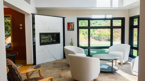 A Residential Sunroom With Fireplace & Glass Windows