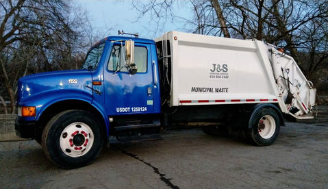 Sanitation Worker Driving Garbage Truck