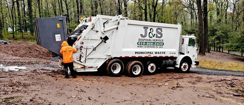 Waste Collector Emptying Dumpster