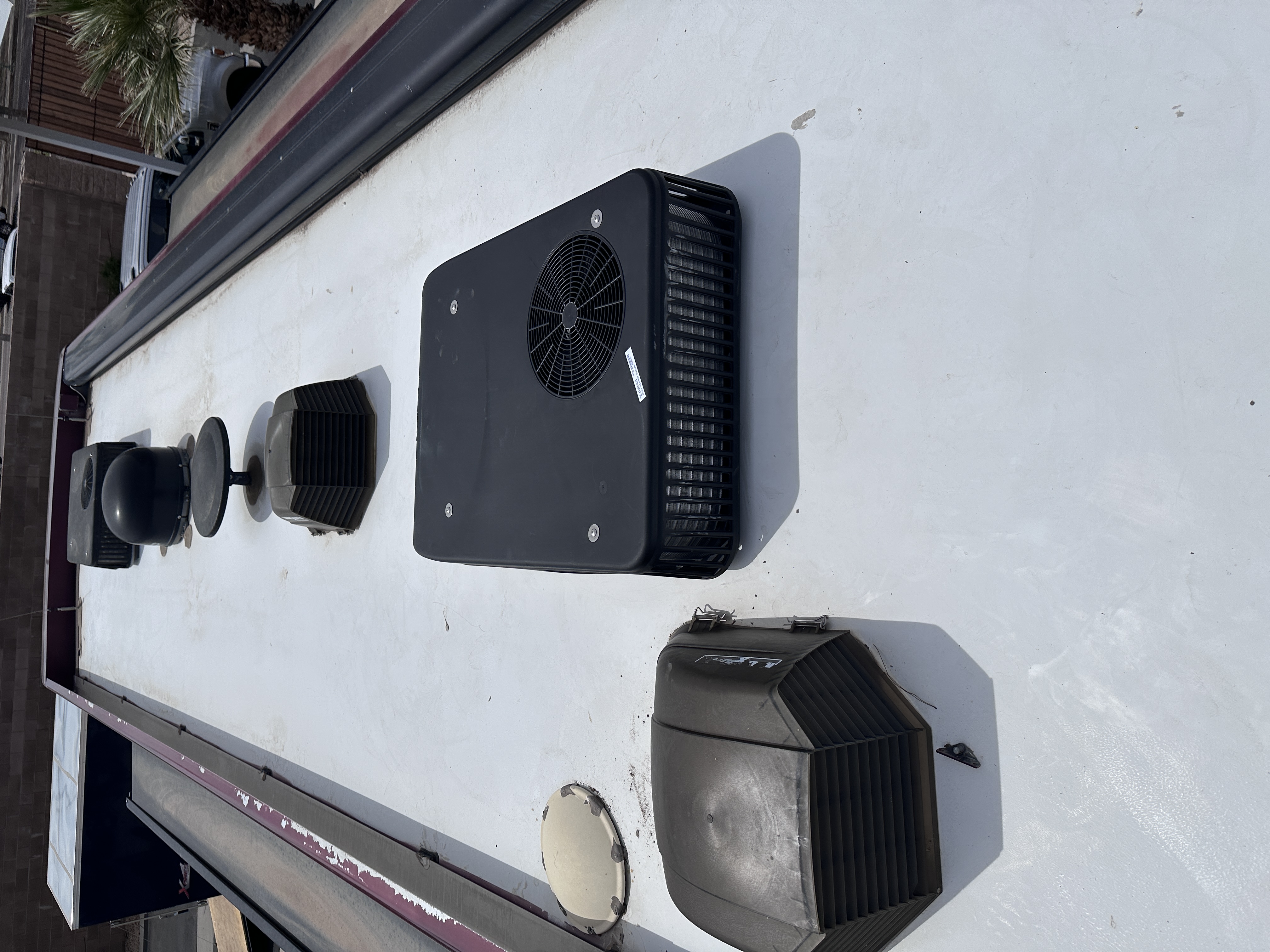 Motorhome rooftop with multiple air-conditioning units, vents and roof-mounted equipment