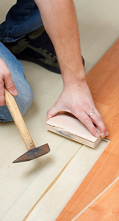 Floor Installer Installing Premium Laminate Flooring, a Hardwood Flooring Alternative