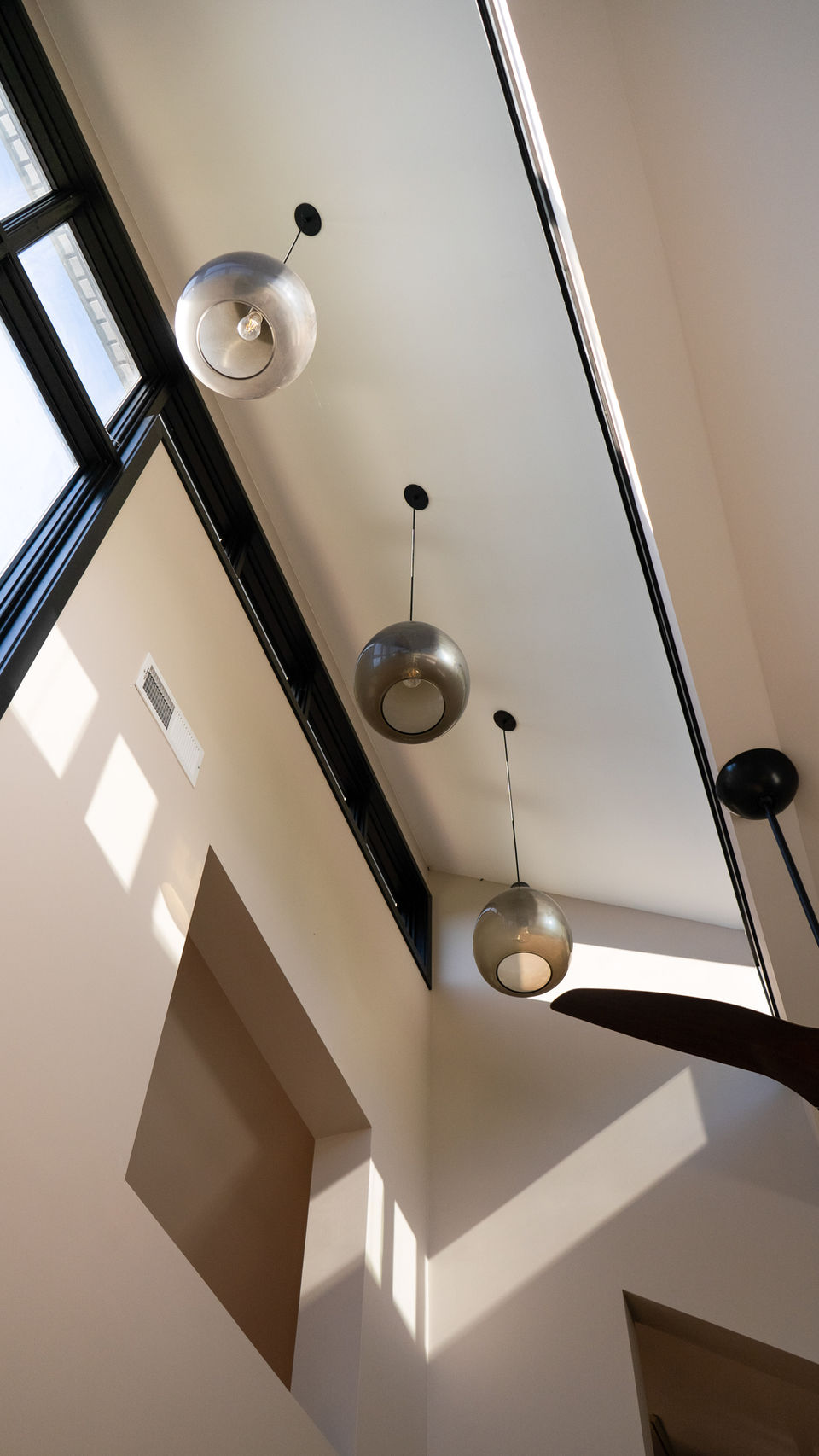 A Sun Room With High End Hanging Lights