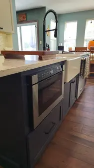 A Kitchen Island With Sink, Microwave, & Other Useful Features