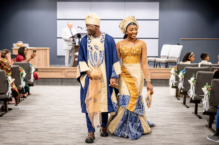 Guillaume and Lemuelle in traditional attire at their wedding.
