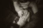 Grandparent holding a grandchild's hand.