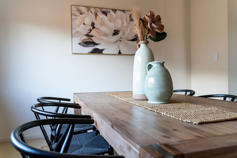 Dining room staged with neutral tones and wishbone chairs