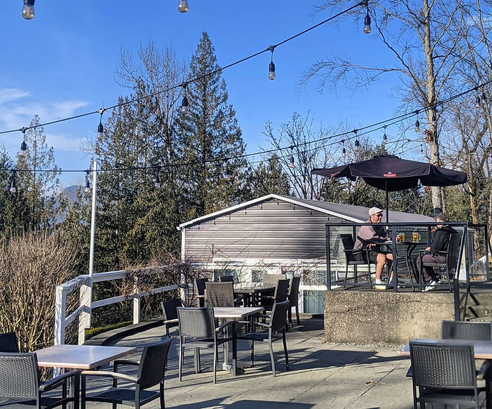 A picture of two people enjoying themselves on a patio.