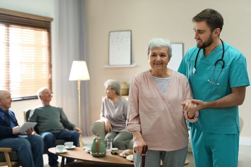 A nurse assisting an old lady