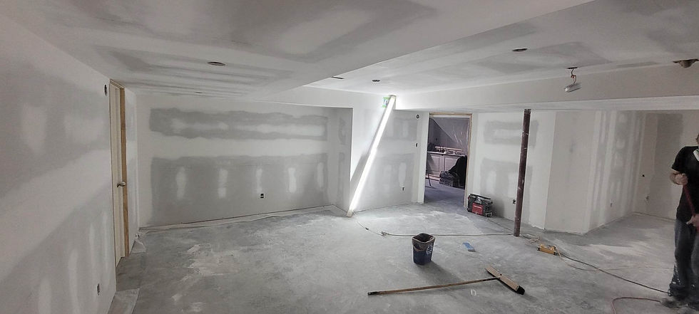 A picture showcasing an empty room with equipment and a worker