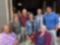 Picture of 7 smiling adults, arms around each other, 4 women, 3 men.