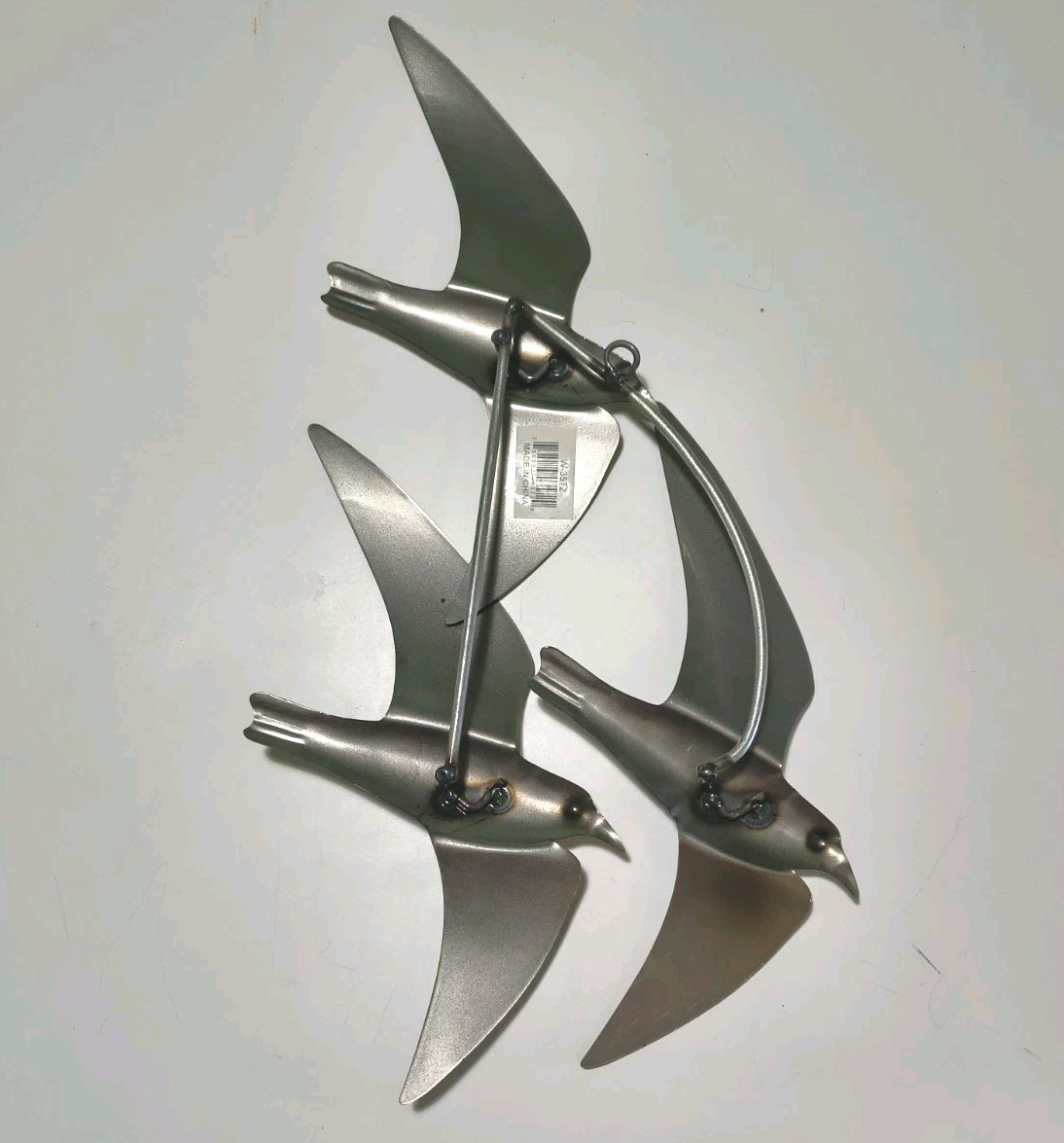 Flock of metal silvery wall seagulls