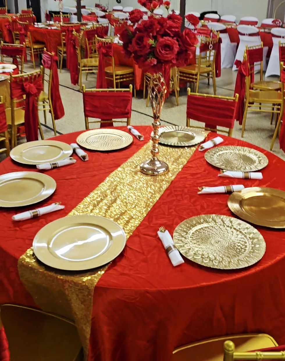 Professional event decoration with red and gold table settings