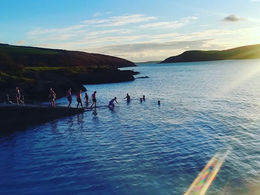 close up of people taking a cold plunge swim after a sauna session at Myhaven Sauna Oysterhaven Cork