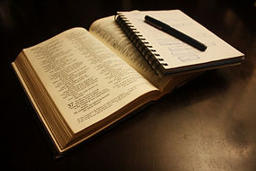 bible with notebook and a pen