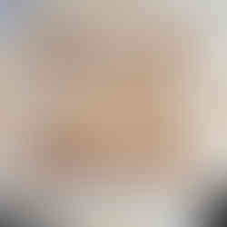 Rust dyed cotton fabric in an embroidery hoop.