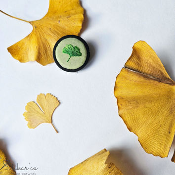 Ginkgo leaf embroidered brooch with yellow ginkgo leaves on white background.