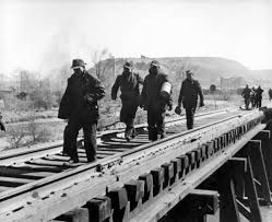 Miners walking across a trestle after working in the coal mines in Nanty Glo, Cambria County.