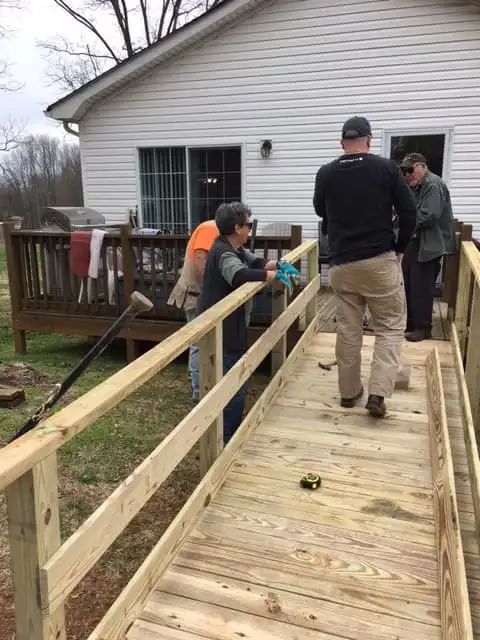 helping build a ramp for an elderly woman