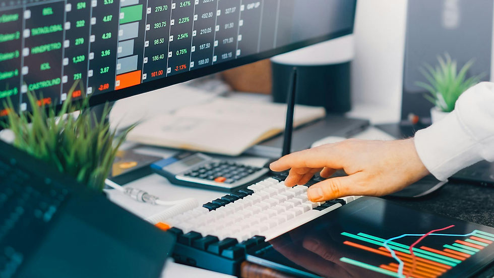 Professional workspace with trading charts and market data on screens, ideal for finance and investment contexts.