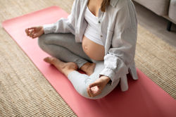 pregnant-woman-doing-yoga-at-home