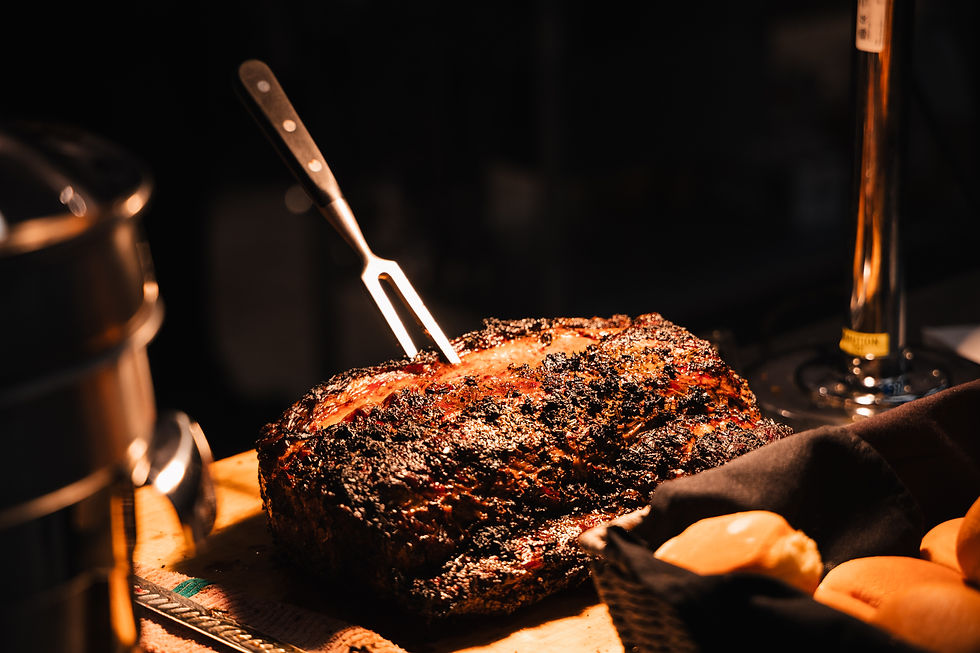 Prime rib under a heat lamp with a forked knife inside