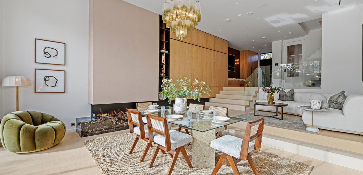 Open-plan split-level dining and reception area with glass dining table on The Avenue