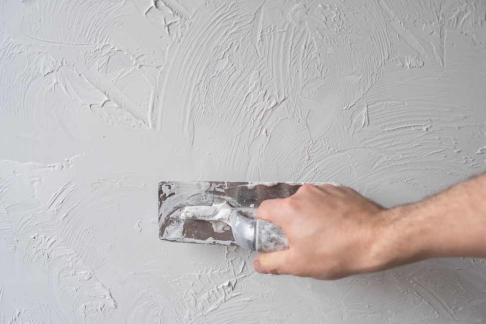 Applying decorative putty. White abstract texture of surface covered with putty. textured